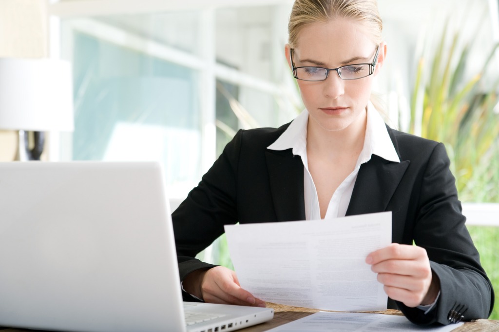 business woman looking over papers picture id175404105