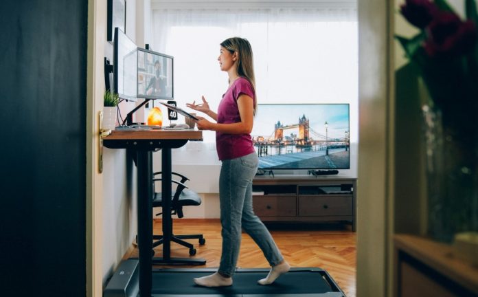 woman at standing desk on video call